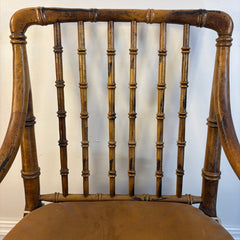 Faux Rattan Armchair with Spindle Back and X Base Stretcher Cognac Leather Pads, Sku 034151
