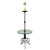 Tall floor lamp with glass table on a plain background