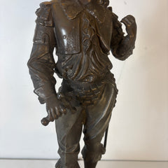Bronze statue of a warrior holding a sword on a white background