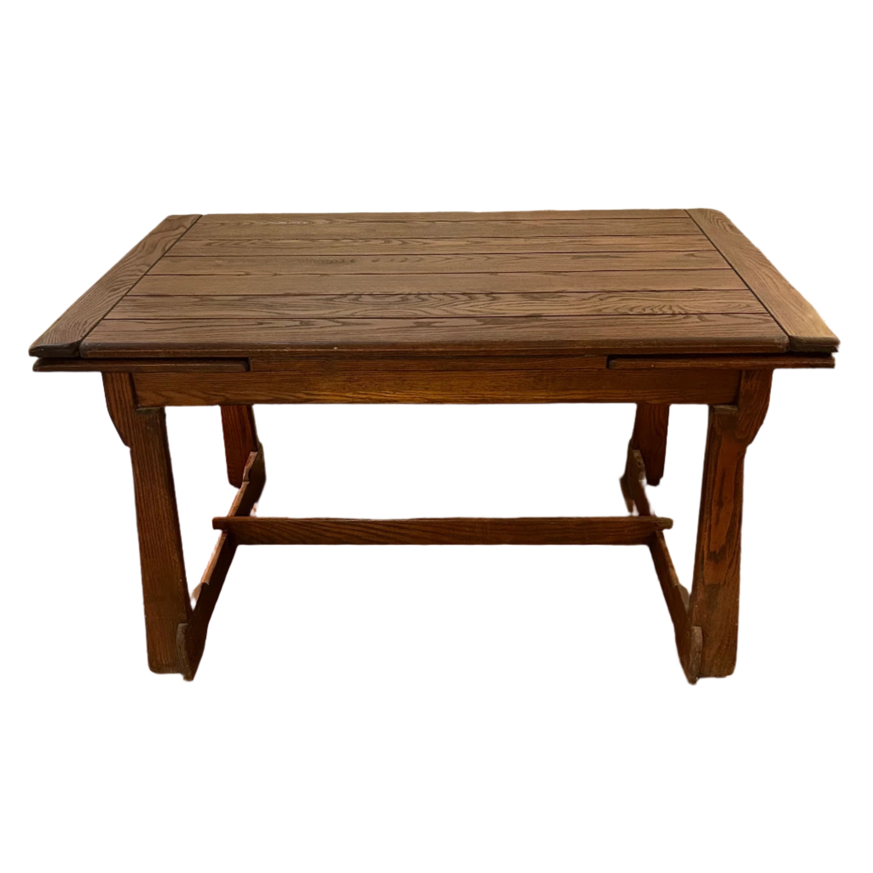 Wooden table with bench against a brick wall.