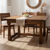 Wooden table with bench against a brick wall.