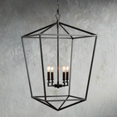 Decorative black chandelier with three lit lights against a textured gray wall.