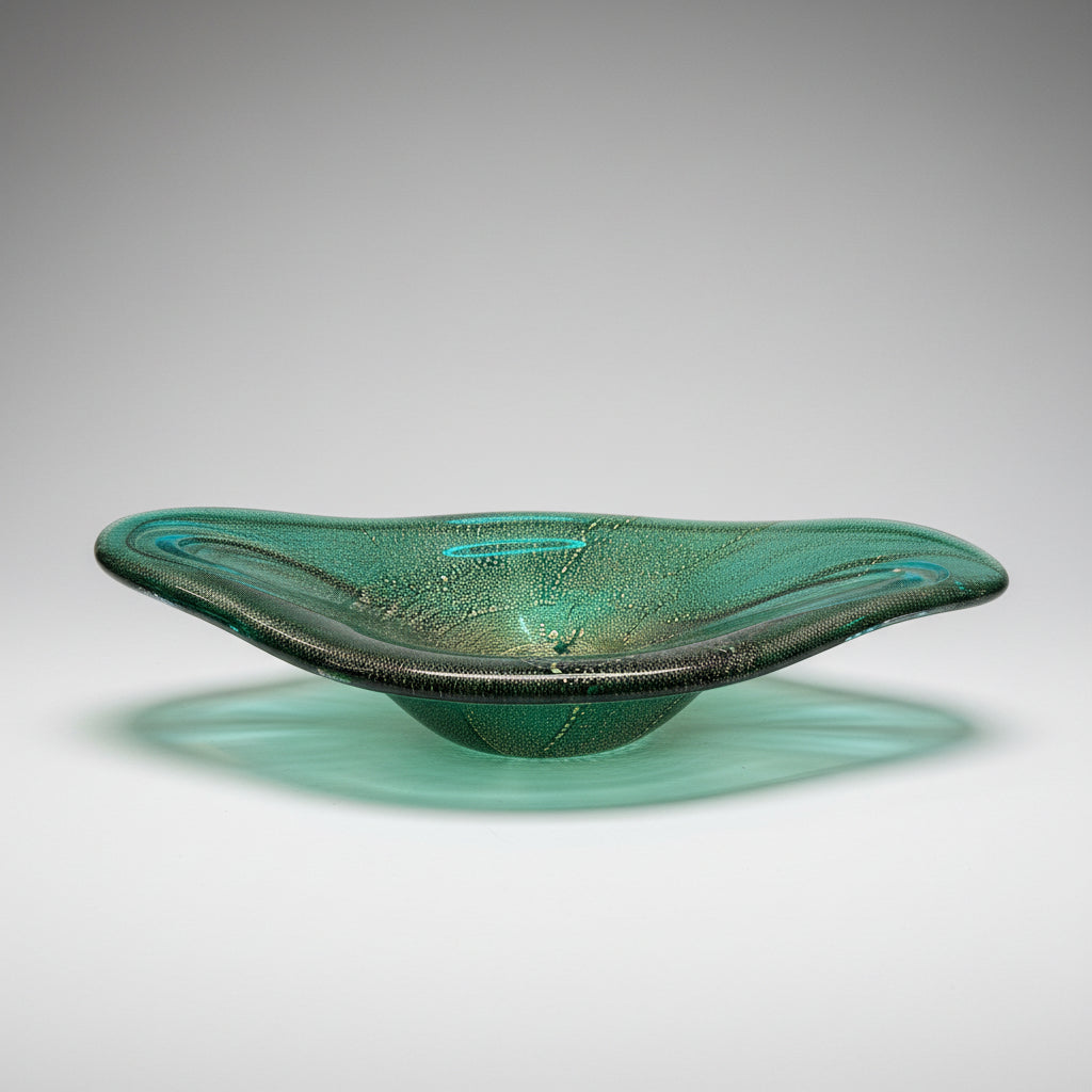 Green glass bowl on a wooden floor
