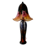 Decorative glass lamp with floral design on a plain background