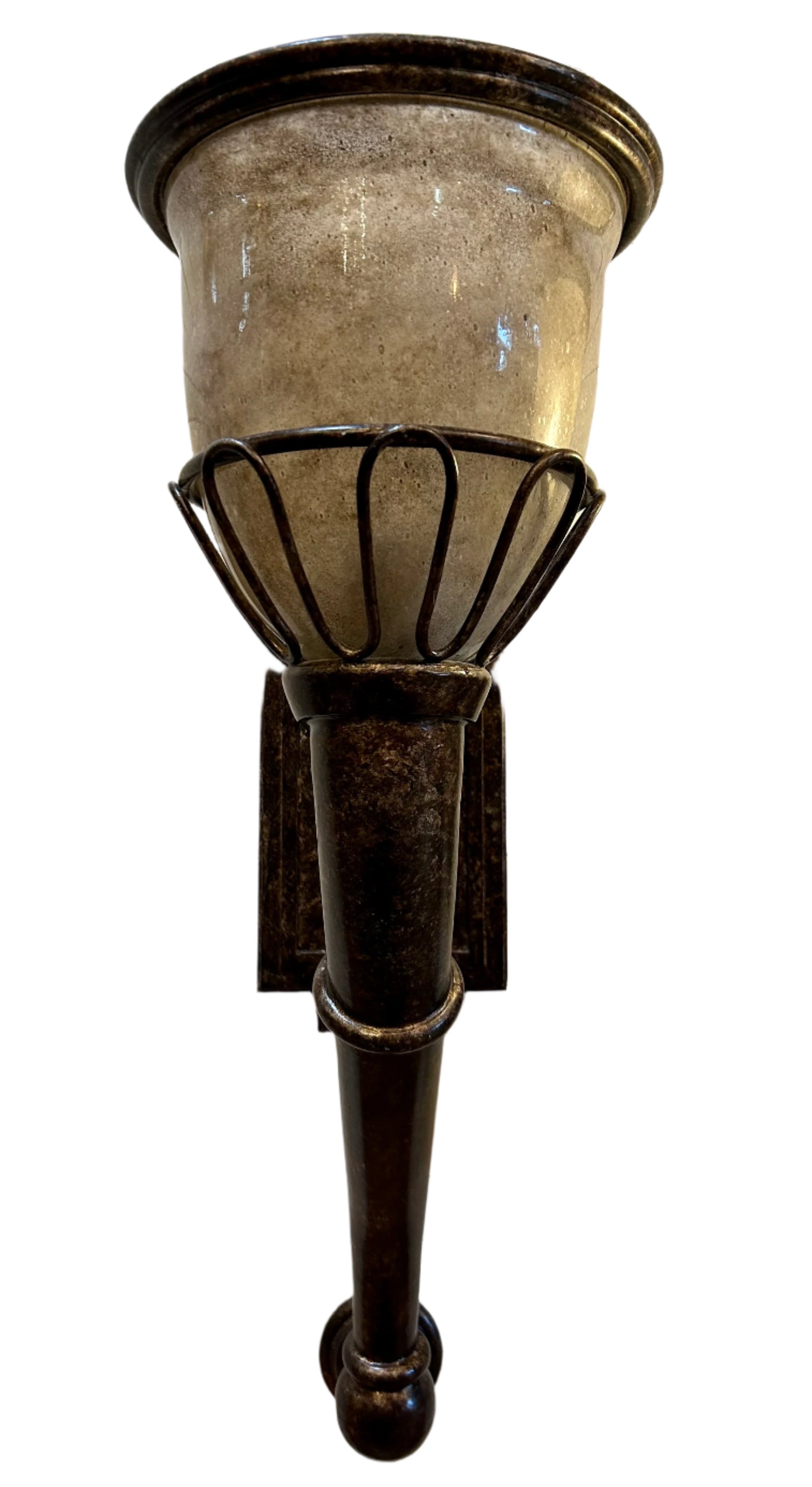 Decorative wall sconce with a metallic finish on a wooden background