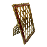 Decorative gold and red frame on a white surface