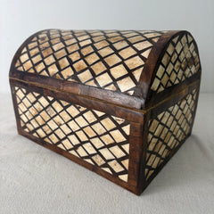 Wooden box with lattice design on a gray surface