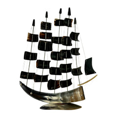 Decorative ship model with multiple sails on a plain background